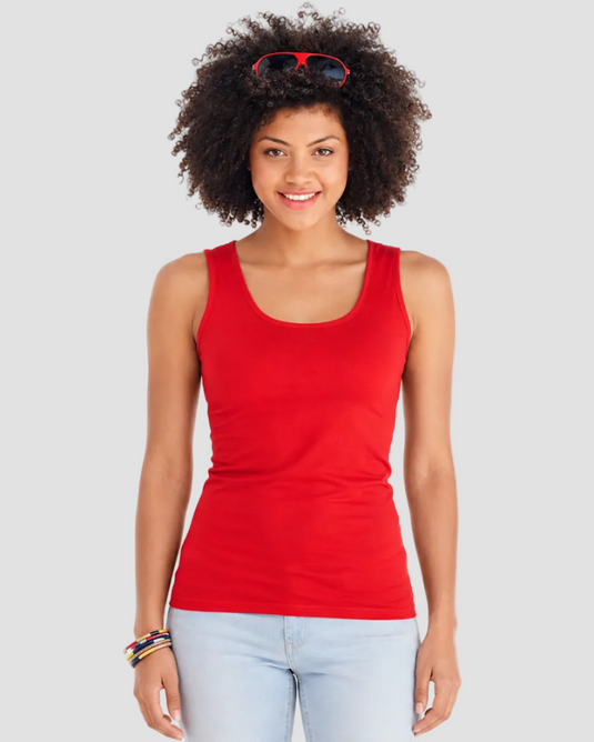 Woman wearing a red tank top and light blue jeans on a white background