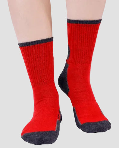 Red socks with black accents worn by a person on a light gray background