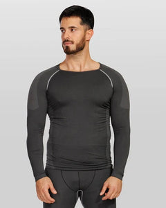 A man wearing a dark gray long-sleeve athletic compression shirt with contrasting light gray shoulder panels and piping, paired with matching dark gray compression pants, set against a solid light gray background.